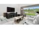 Bright living area features a large TV and sliding glass doors with serene views at 3559 Maple Bay Ln, Land O Lakes, FL 34638