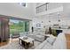 Open-concept living room boasts high ceilings and seamless flow to the modern kitchen at 3559 Maple Bay Ln, Land O Lakes, FL 34638