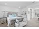 Spacious main bedroom featuring a luxurious bed, elegant decor, and access to an ensuite bathroom at 3559 Maple Bay Ln, Land O Lakes, FL 34638