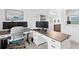 Bright home office featuring dual monitors, a gray and white desk, and plenty of natural light at 3559 Maple Bay Ln, Land O Lakes, FL 34638