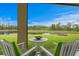 Inviting patio with comfortable seating overlooking a tranquil lake and lush greenery, perfect for relaxation at 3559 Maple Bay Ln, Land O Lakes, FL 34638