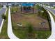 Aerial view of a community playground with benches and surrounding green space at 3559 Maple Bay Ln, Land O Lakes, FL 34638