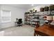 Well-organized room with shelving unit, desk and carpet at 3559 Maple Bay Ln, Land O Lakes, FL 34638