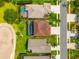 Aerial view of the properties showcasing the backyard pools and landscaping at 3633 Morgans Bluff Ct, Land O Lakes, FL 34639