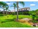 Beautiful backyard with lush greenery and tropical palms surrounding a home at 3633 Morgans Bluff Ct, Land O Lakes, FL 34639