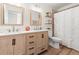 Bright bathroom with wood-look floors, a double vanity, and a shower with a decorative shower curtain at 3633 Morgans Bluff Ct, Land O Lakes, FL 34639
