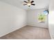 Bright bedroom with carpet, a ceiling fan, and a wall mounted TV at 3633 Morgans Bluff Ct, Land O Lakes, FL 34639