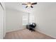 Bright bedroom with carpet, a ceiling fan, and a desk with a black office chair at 3633 Morgans Bluff Ct, Land O Lakes, FL 34639