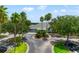 Beautifully landscaped clubhouse entrance with circular driveway and mature palm trees at 3633 Morgans Bluff Ct, Land O Lakes, FL 34639
