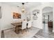 Dining area featuring a rustic table, neutral-toned chairs, and a decorative chandelier at 3633 Morgans Bluff Ct, Land O Lakes, FL 34639