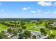 Stunning aerial view of a manicured golf course with a lake and inviting clubhouse at 3633 Morgans Bluff Ct, Land O Lakes, FL 34639