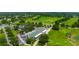 Picturesque aerial view of a golf course featuring greens, trees, and surrounding landscape at 3633 Morgans Bluff Ct, Land O Lakes, FL 34639