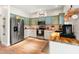 Kitchen with two-tone cabinets, stainless steel appliances, and a stylish butcher block countertop at 3633 Morgans Bluff Ct, Land O Lakes, FL 34639