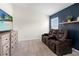 Comfortable seating in media room with mounted tv and custom shelving at 3633 Morgans Bluff Ct, Land O Lakes, FL 34639