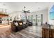 Open-concept living room with modern flooring, lots of natural light, and stylish furnishings at 3633 Morgans Bluff Ct, Land O Lakes, FL 34639