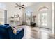 Bright living room featuring wood flooring, an arched doorway, and two large windows at 3633 Morgans Bluff Ct, Land O Lakes, FL 34639