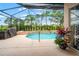 A covered pool with a hot tub and screen enclosure with lush landscaping at 3633 Morgans Bluff Ct, Land O Lakes, FL 34639