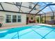 Charming pool featuring a screened-in enclosure and outdoor patio at 3633 Morgans Bluff Ct, Land O Lakes, FL 34639