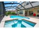 Beautiful screen enclosed pool and spa with an outdoor entertainment area at 3633 Morgans Bluff Ct, Land O Lakes, FL 34639
