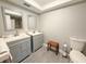 Well-lit bathroom with double sinks, gray cabinets, and a modern design at 3854 Trophy Blvd, New Port Richey, FL 34655