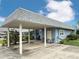 A spacious carport beside the residence provides shelter for vehicles and outdoor seating at 3854 Trophy Blvd, New Port Richey, FL 34655