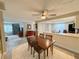 Dining area connected to the living room and kitchen, featuring a wooden table with seating for four at 3854 Trophy Blvd, New Port Richey, FL 34655