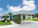 Charming home featuring a covered carport and lovely landscaping with flowering bushes at 3854 Trophy Blvd, New Port Richey, FL 34655