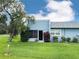 Charming single-story home with a well-manicured lawn and mature tree at 3854 Trophy Blvd, New Port Richey, FL 34655