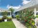 Welcoming front yard with a sidewalk leading to the entrance, enhanced by vibrant floral landscaping at 3854 Trophy Blvd, New Port Richey, FL 34655