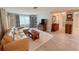 Inviting living room featuring a comfortable leather sofa, stylish decor, and lots of natural light at 3854 Trophy Blvd, New Port Richey, FL 34655