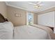 Cozy bedroom featuring a bright window, ceiling fan, closet, and neutral tones at 3905 31St W Ave, Bradenton, FL 34205