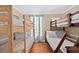 Bedroom features two sets of bunk beds, wood-look tile flooring, and a bright window at 3905 31St W Ave, Bradenton, FL 34205