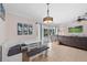 Inviting dining nook with a bench seat and modern light fixture, open to the living space at 3905 31St W Ave, Bradenton, FL 34205