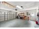 Spacious garage with shelving for storage, work tables, and a large garage door at 3905 31St W Ave, Bradenton, FL 34205