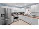 Stylish kitchen with white cabinetry, stainless steel appliances, and wood countertops at 3905 31St W Ave, Bradenton, FL 34205