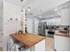 Bright kitchen with white cabinets, butcher block countertops, and stainless steel appliances at 3905 31St W Ave, Bradenton, FL 34205