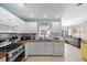 Well-lit kitchen featuring white cabinets, stainless steel appliances, and butcher block counters at 3905 31St W Ave, Bradenton, FL 34205