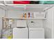 This laundry room features a full size washer and dryer, water heater, and shelving for storage at 3905 31St W Ave, Bradenton, FL 34205