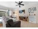 Cozy living room featuring a comfortable sofa, wall-mounted TV, and stylish decor at 3905 31St W Ave, Bradenton, FL 34205