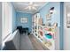 Inviting home office featuring a gray futon, white bookshelves, and nautical decor at 3905 31St W Ave, Bradenton, FL 34205