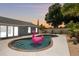 Beautiful backyard pool at dusk, complete with a flamingo float and updated landscaping at 3905 31St W Ave, Bradenton, FL 34205