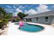 Backyard pool area featuring a flamingo float, covered patio, and updated landscaping at 3905 31St W Ave, Bradenton, FL 34205