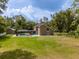 Picturesque home exterior with expansive backyard, featuring a screened-in pool and private setting at 4044 Red Fox Ct, Wesley Chapel, FL 33543