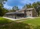 Large, private backyard with a screened-in pool perfect for summer relaxation and entertaining at 4044 Red Fox Ct, Wesley Chapel, FL 33543