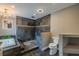 This bathroom features a jacuzzi tub, walk-in shower with stone accents, a toilet, and a sleek chandelier at 4044 Red Fox Ct, Wesley Chapel, FL 33543