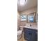 Bathroom with blue vanity, modern fixtures, and marble countertop at 4044 Red Fox Ct, Wesley Chapel, FL 33543