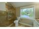 Bathroom with a glass shower, toilet, and sink with granite countertops near a bright window at 4044 Red Fox Ct, Wesley Chapel, FL 33543
