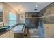 This bathroom features a luxurious soaking tub with stone accents, chandelier, and a spacious walk-in shower at 4044 Red Fox Ct, Wesley Chapel, FL 33543