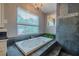 Bathroom showcasing a large soaking tub with jacuzzi jets and stone accents, perfect for relaxation at 4044 Red Fox Ct, Wesley Chapel, FL 33543