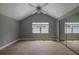 Bedroom features vaulted ceilings, mirrored closet, and natural light from a large window at 4044 Red Fox Ct, Wesley Chapel, FL 33543